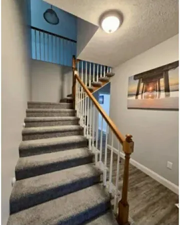 a view of entryway and hall with wooden floor