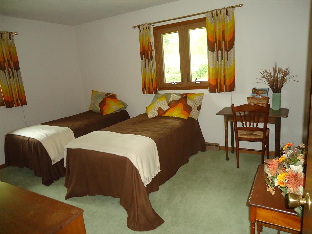 5224 Brookview Road Rockford, IL 61107 - Photo 11 of 22 a bedroom with two beds and a potted plant next to a window