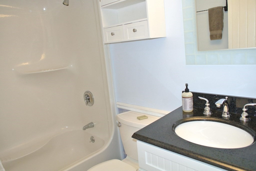 16 Brant Rock Road Mashpee, MA 02649 - Photo 14 of 22 a bathroom with a granite countertop sink and a mirror