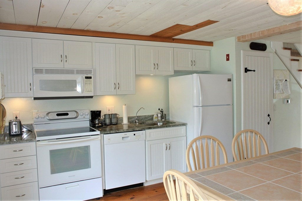 16 Brant Rock Road Mashpee, MA 02649 - Photo 3 of 22 a kitchen with white cabinets and appliances