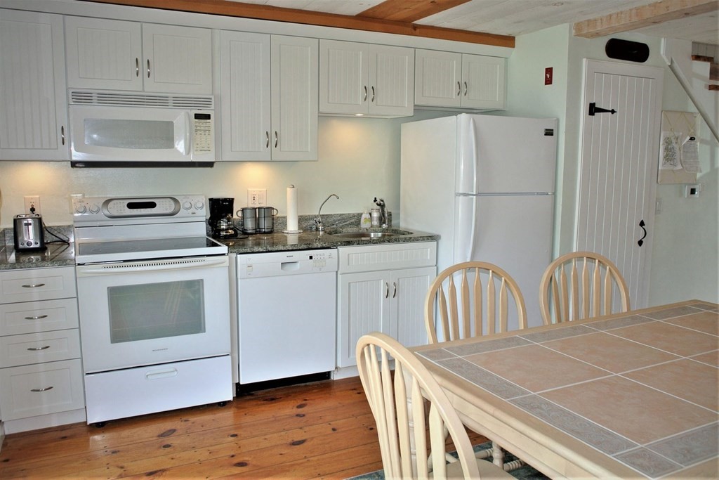 16 Brant Rock Road Mashpee, MA 02649 - Photo 4 of 22 a kitchen with stainless steel appliances a stove a sink cabinets and a refrigerator