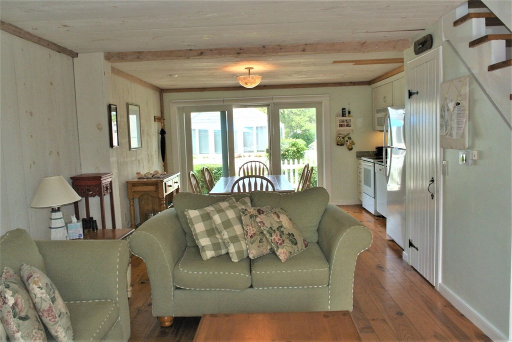16 Brant Rock Road Mashpee, MA 02649 - Photo 8 of 22 a living room with furniture and a chandelier