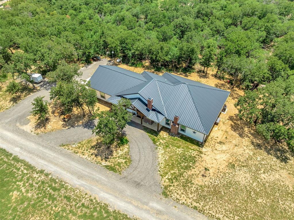 129 Whiskey Rnch Road Runaway Bay, TX 76426 - Photo 34 of 39 a view of a house with a yard