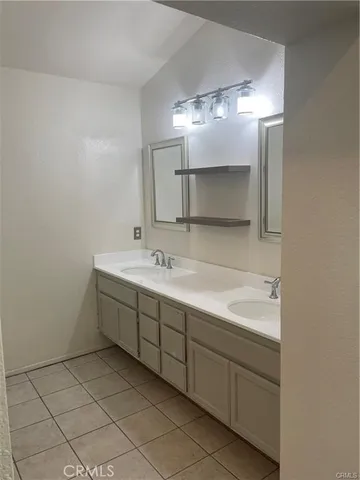 a bathroom with a sink double vanity and a mirror