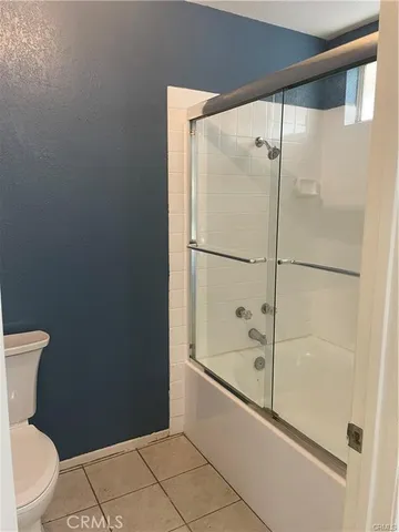 a bathroom with a shower and a toilet
