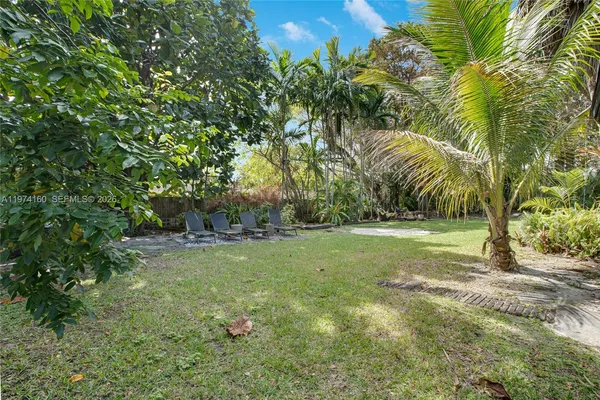 a view of a backyard with large trees