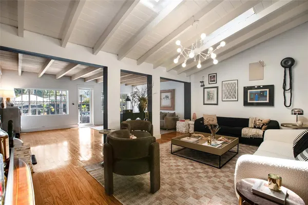 a living room with furniture and a chandelier