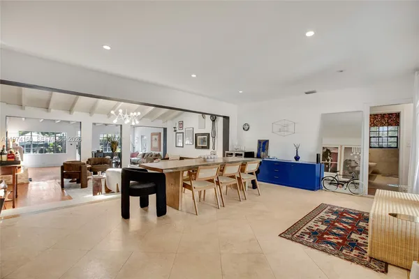 a living room with furniture a rug and a table