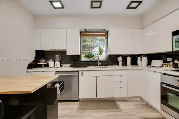 a kitchen with a sink cabinets and window