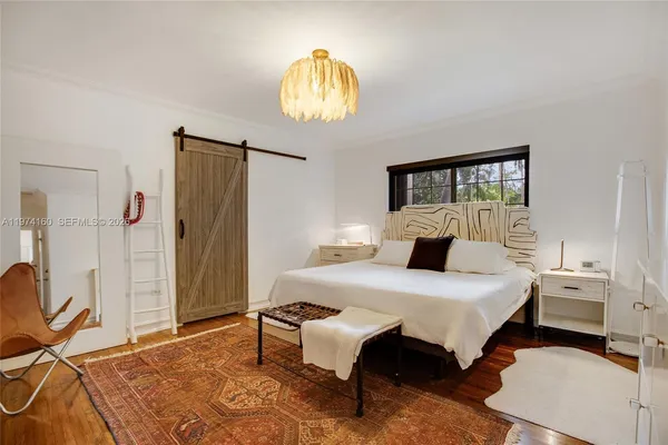 a bedroom with a bed and a chandelier