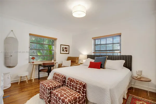 a bedroom with double bed and a window