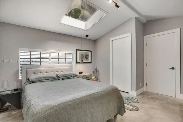 a bedroom with a bed and a window