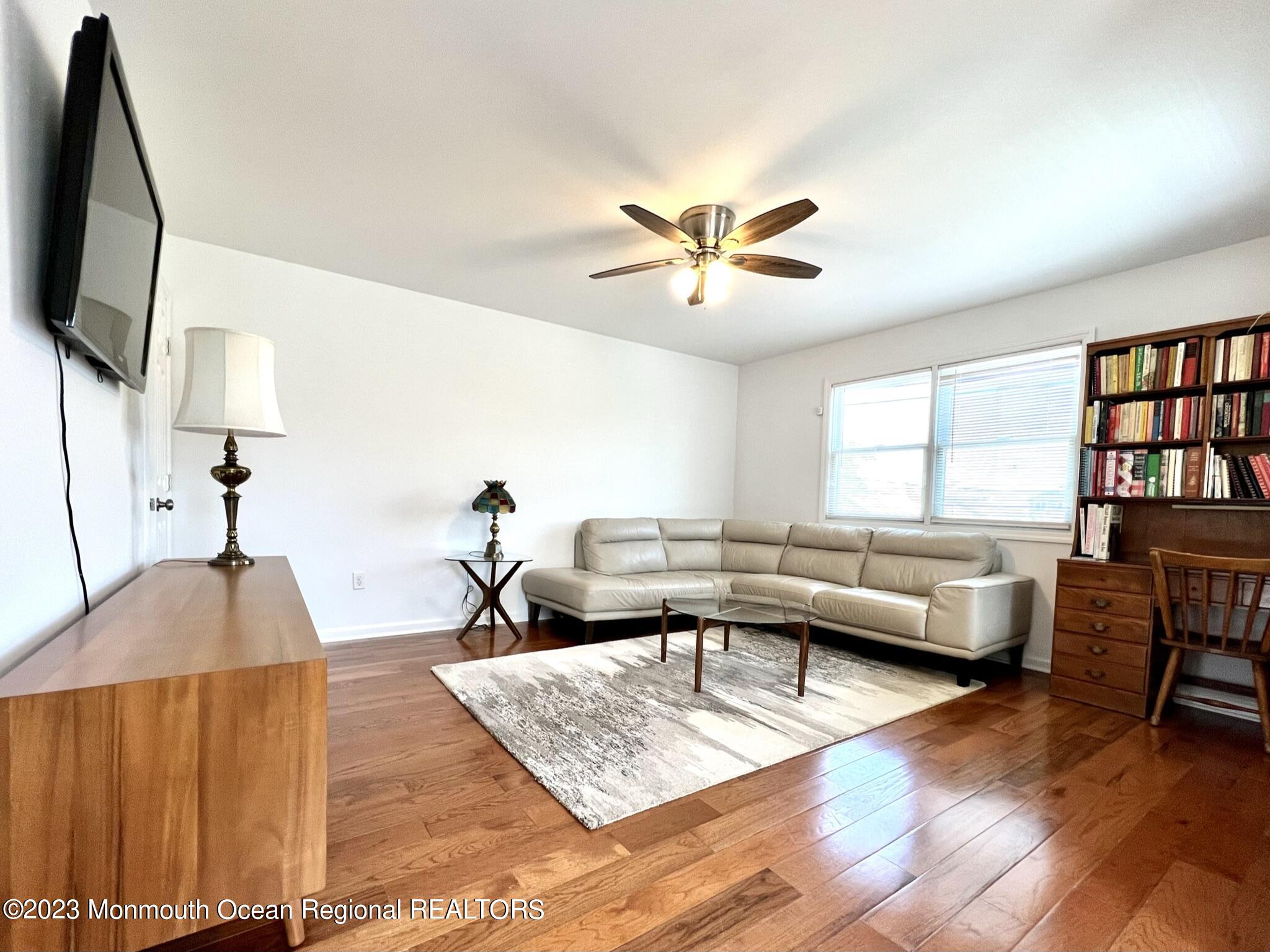 a living room with furniture fireplace and a window