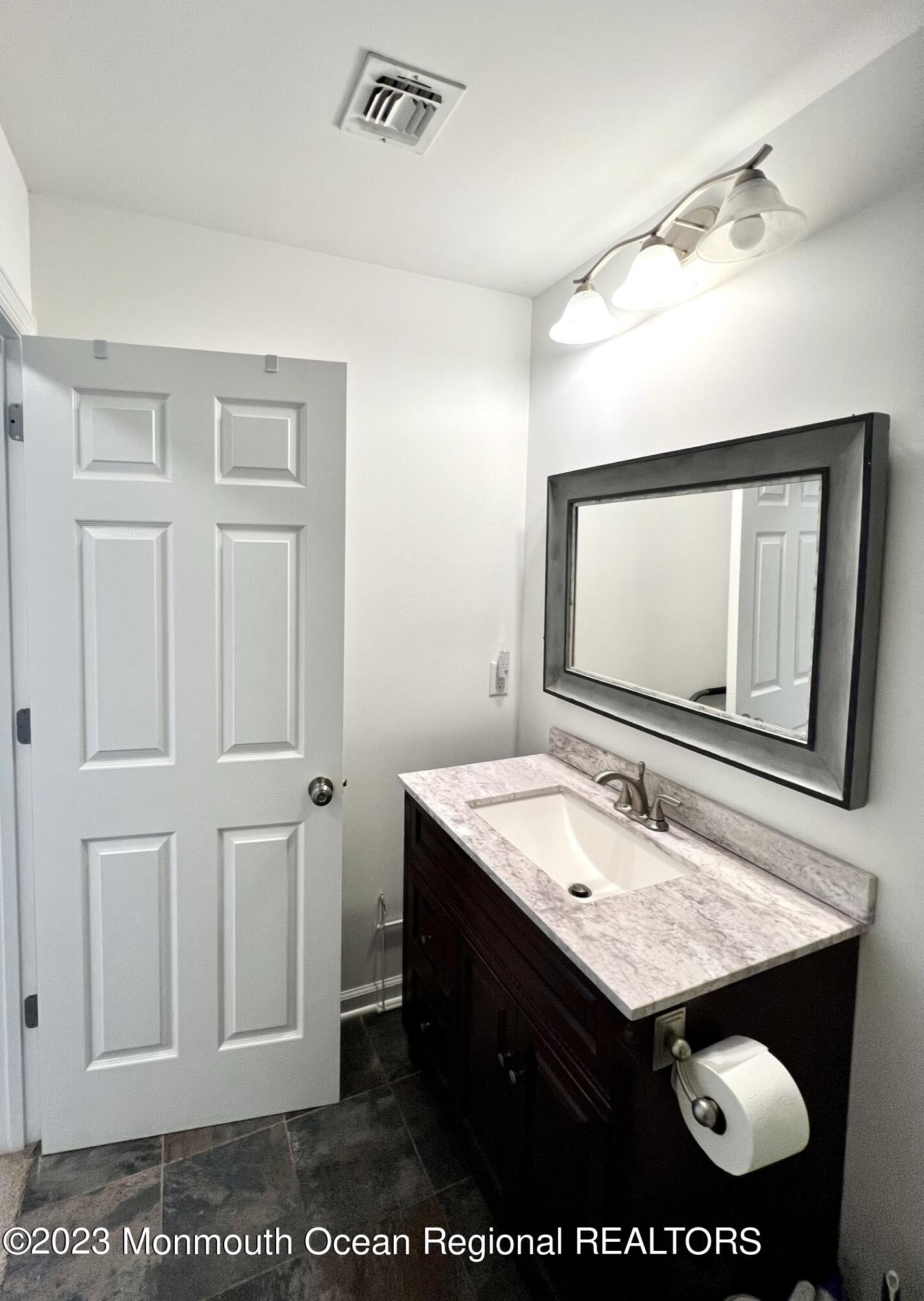 13 Appleton Avenue Leonardo, NJ 07737 - Photo 12 of 19 a bathroom with a sink a vanity and a mirror