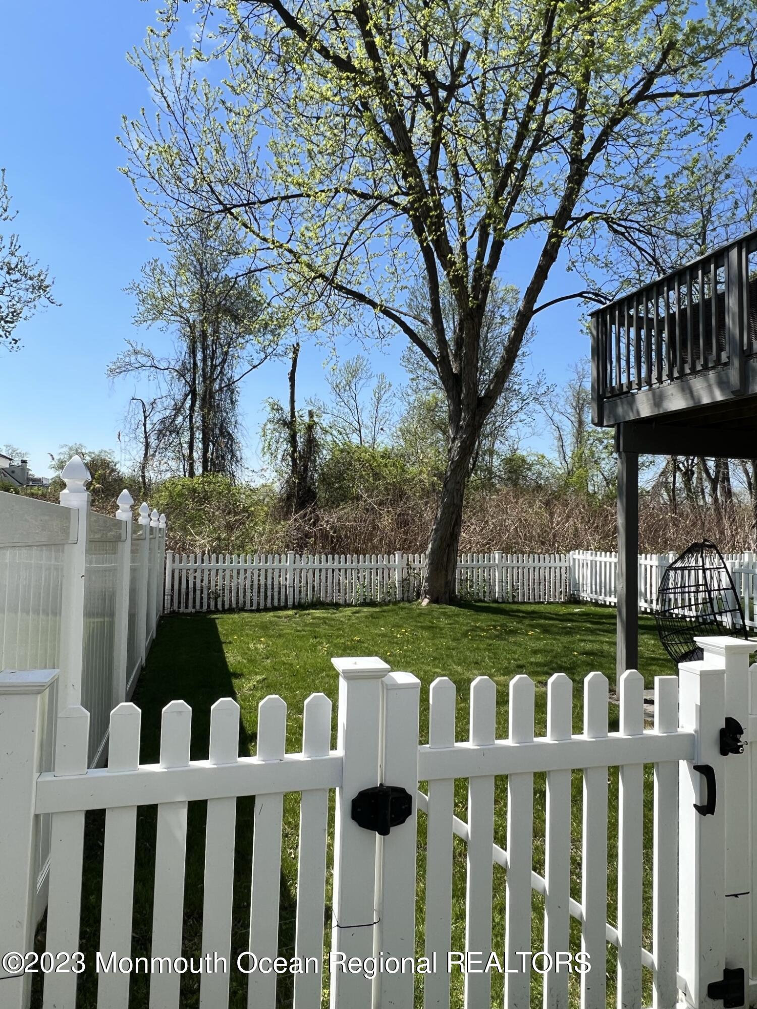 13 Appleton Avenue Leonardo, NJ 07737 - Photo 18 of 19 a view of a wooden deck and lake with trees in the background