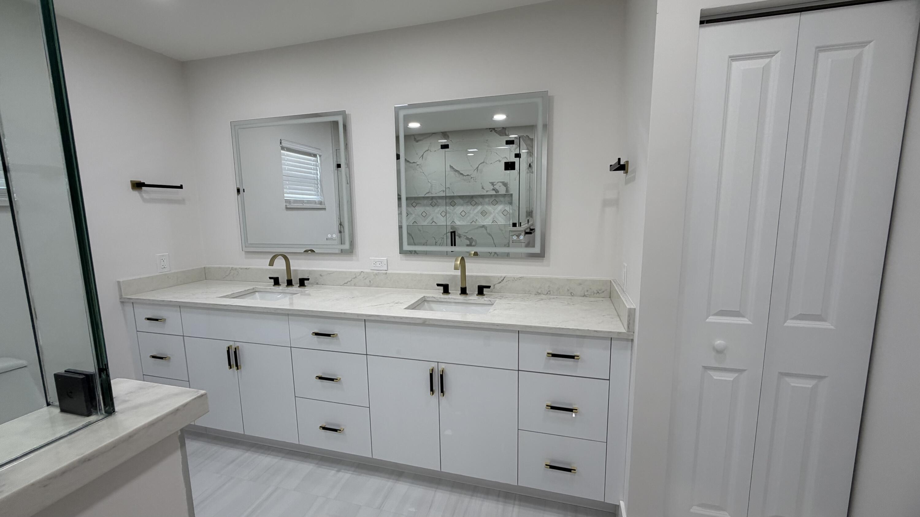 2521 Northeast 45th Street Lighthouse Point, FL 33064 - Photo 14 of 25 a bathroom with double vanity sink a mirror and a vanity