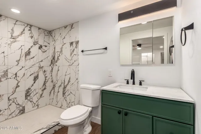 a bathroom with a sink toilet and shower