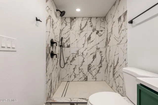 a bathroom with a toilet and shower curtain
