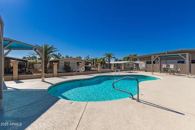 a view of a swimming pool with outdoor seating