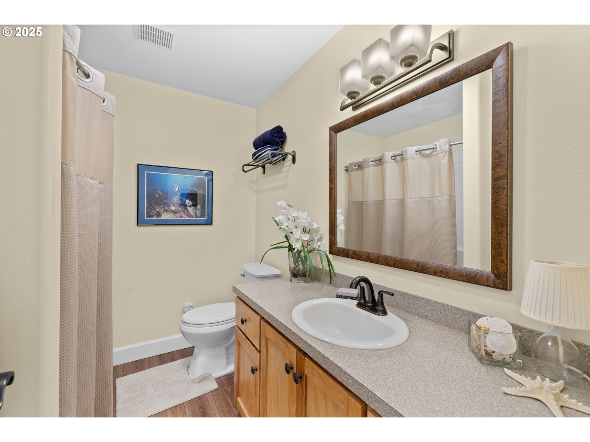 420 Elk Creek Road, Unit 503 Cannon Beach, OR 97110 - Photo 13 of 25 a bathroom with a granite countertop sink and a mirror