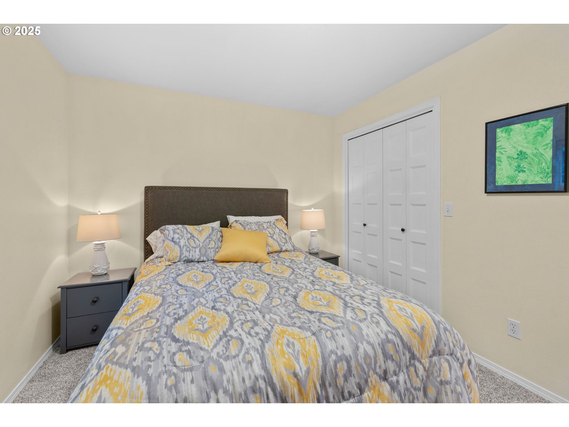 420 Elk Creek Road, Unit 503 Cannon Beach, OR 97110 - Photo 17 of 25 a bed sitting in a bedroom and a lamp