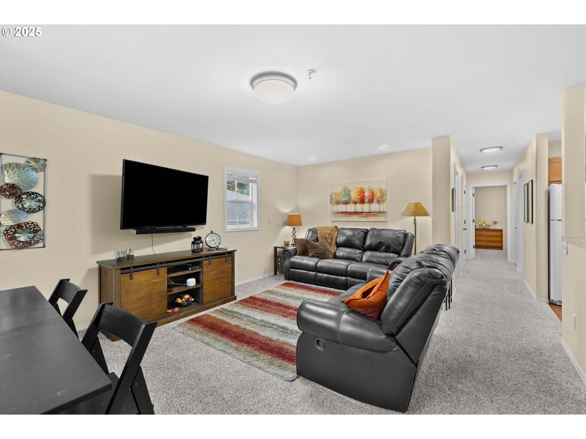 420 Elk Creek Road, Unit 503 Cannon Beach, OR 97110 - Photo 2 of 25 a living room with furniture and a flat screen tv