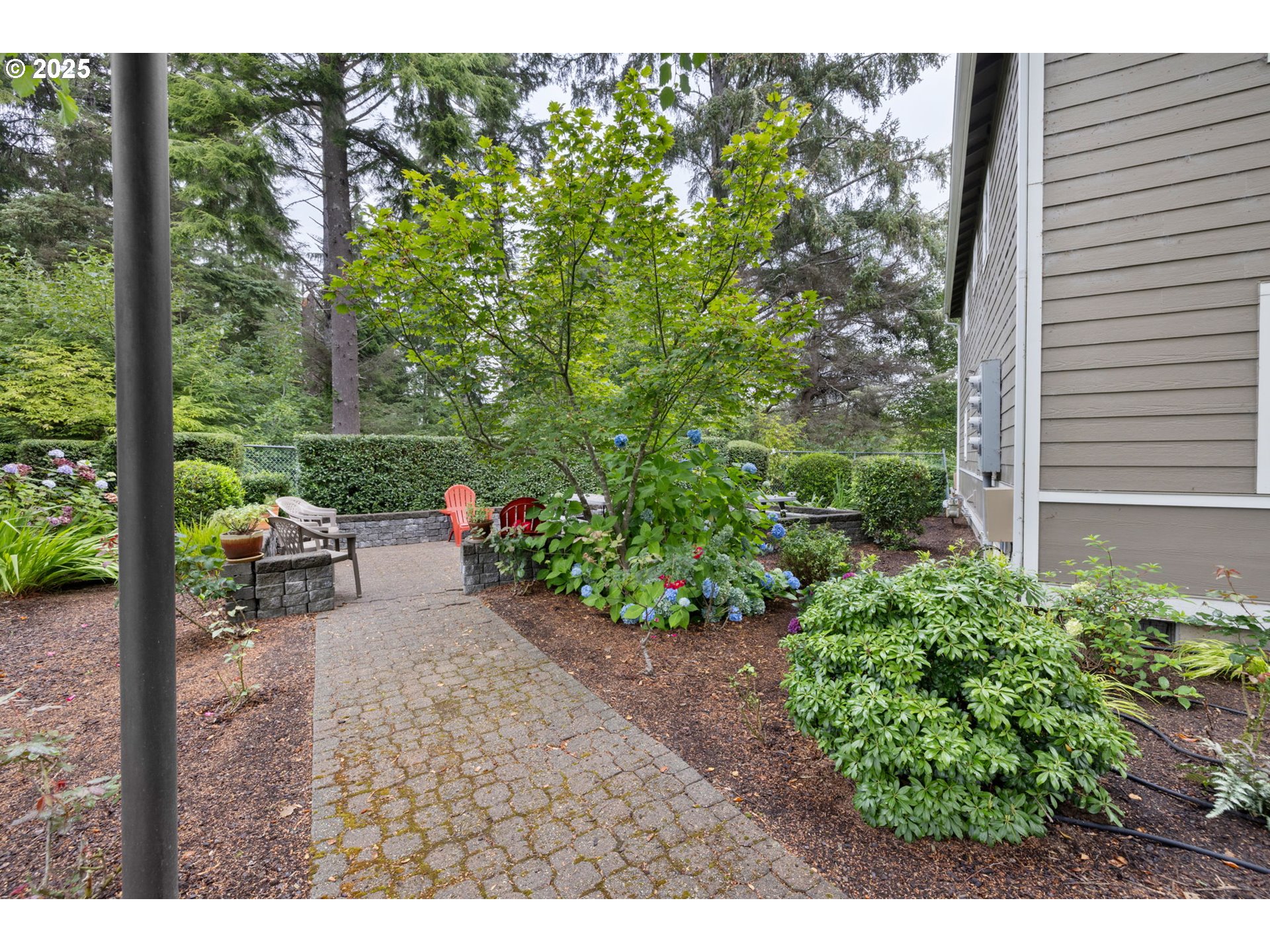 420 Elk Creek Road, Unit 503 Cannon Beach, OR 97110 - Photo 23 of 25 a view of a patio with table and chairs and potted plants