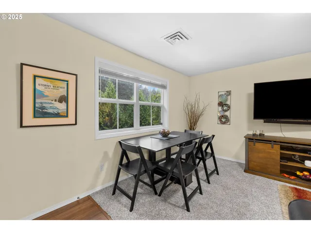 a view of a dining room with furniture window and outside view