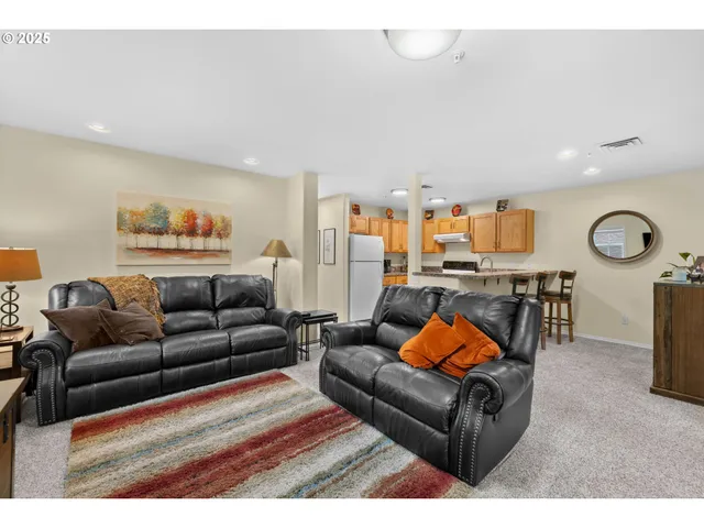 a living room with furniture a rug and a large window