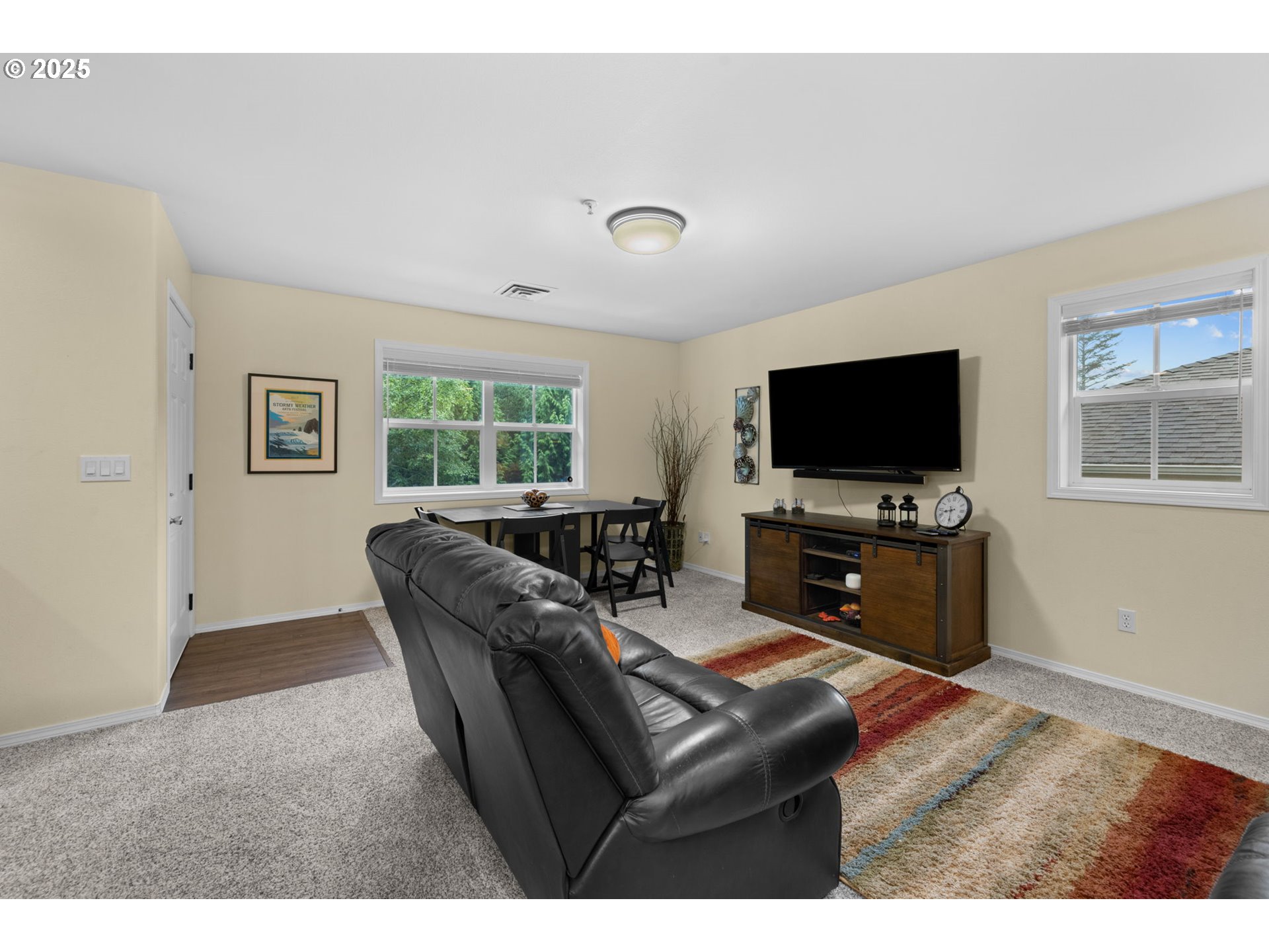 420 Elk Creek Road, Unit 503 Cannon Beach, OR 97110 - Photo 6 of 25 a living room with furniture and a flat screen tv