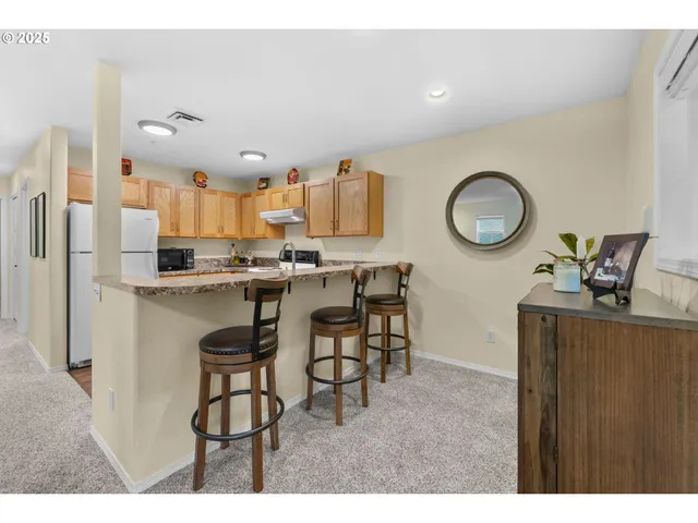 a kitchen with stainless steel appliances granite countertop a refrigerator sink and stove