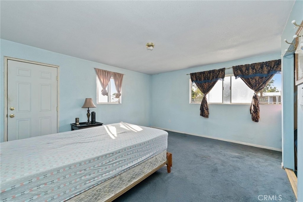 8925 Penny Drive Riverside, CA 92503 - Photo 21 of 48 a bedroom with a bed and window