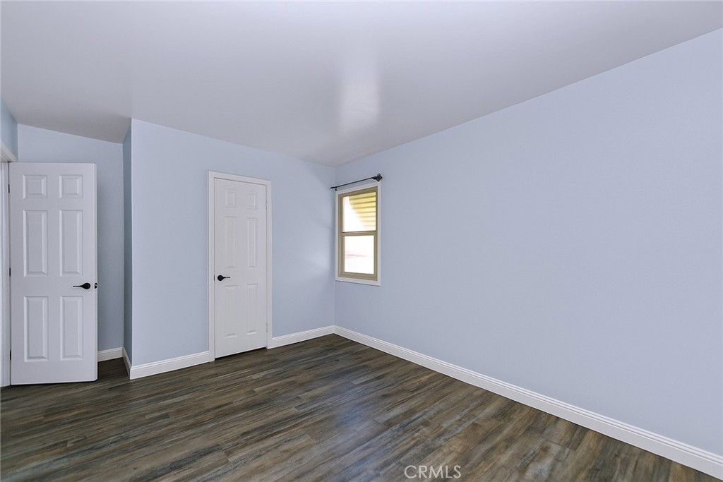 8925 Penny Drive Riverside, CA 92503 - Photo 22 of 48 a view of an empty room with wooden floor and window