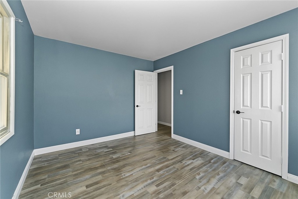 8925 Penny Drive Riverside, CA 92503 - Photo 24 of 48 a view of an empty room with wooden floor and a window