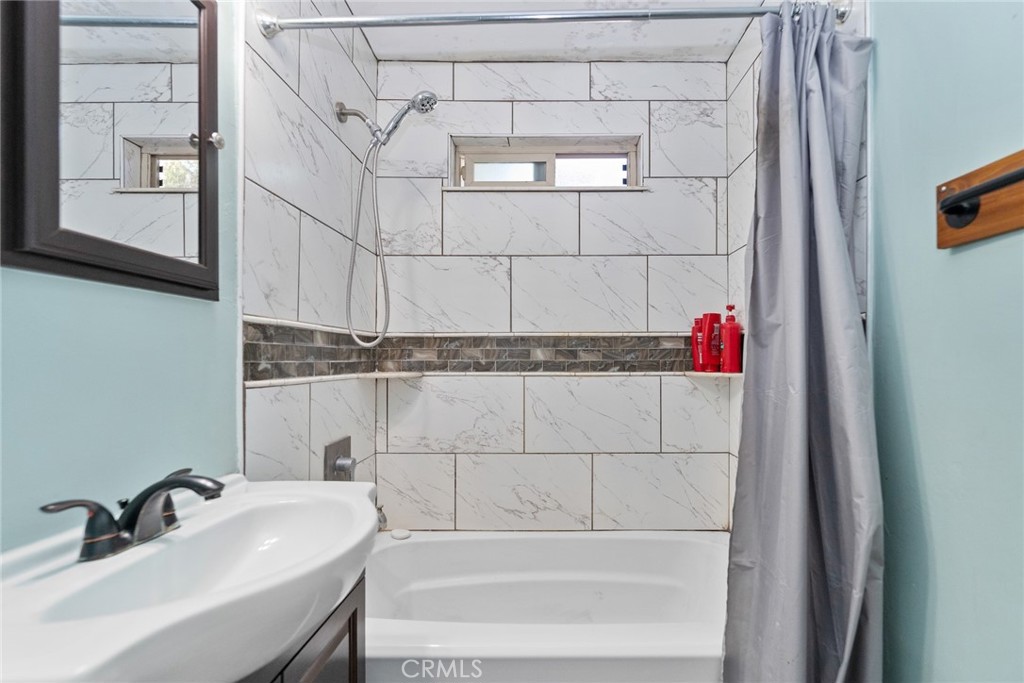 8925 Penny Drive Riverside, CA 92503 - Photo 25 of 48 a bathroom with a sink and a shower