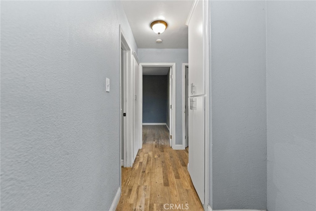 8925 Penny Drive Riverside, CA 92503 - Photo 26 of 48 a view of a hallway with wooden floor