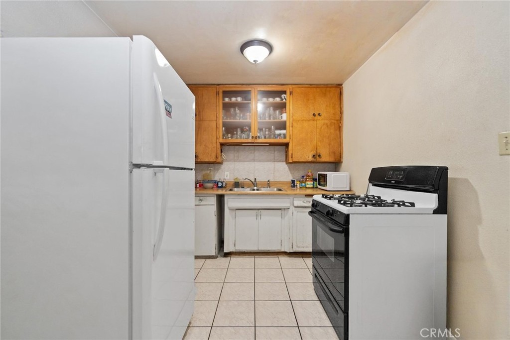 8925 Penny Drive Riverside, CA 92503 - Photo 27 of 48 a kitchen with a refrigerator and a stove