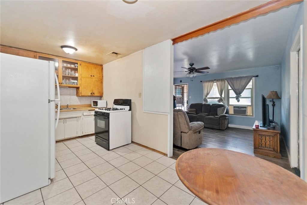 8925 Penny Drive Riverside, CA 92503 - Photo 28 of 48 a kitchen with a sink dishwasher stove and refrigerator