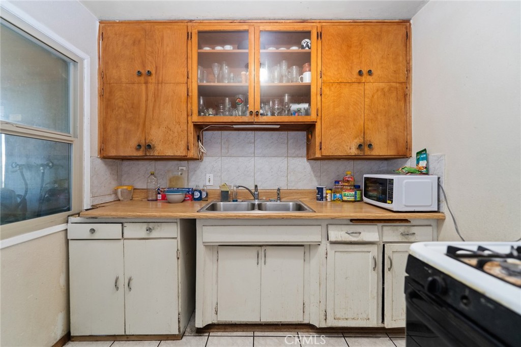 8925 Penny Drive Riverside, CA 92503 - Photo 29 of 48 a kitchen with stainless steel appliances granite countertop a sink stove and cabinets