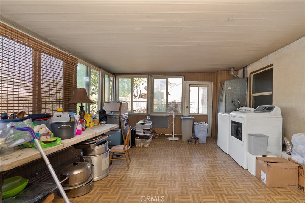 8925 Penny Drive Riverside, CA 92503 - Photo 32 of 48 a room with furniture a rug staircase and a open kitchen view