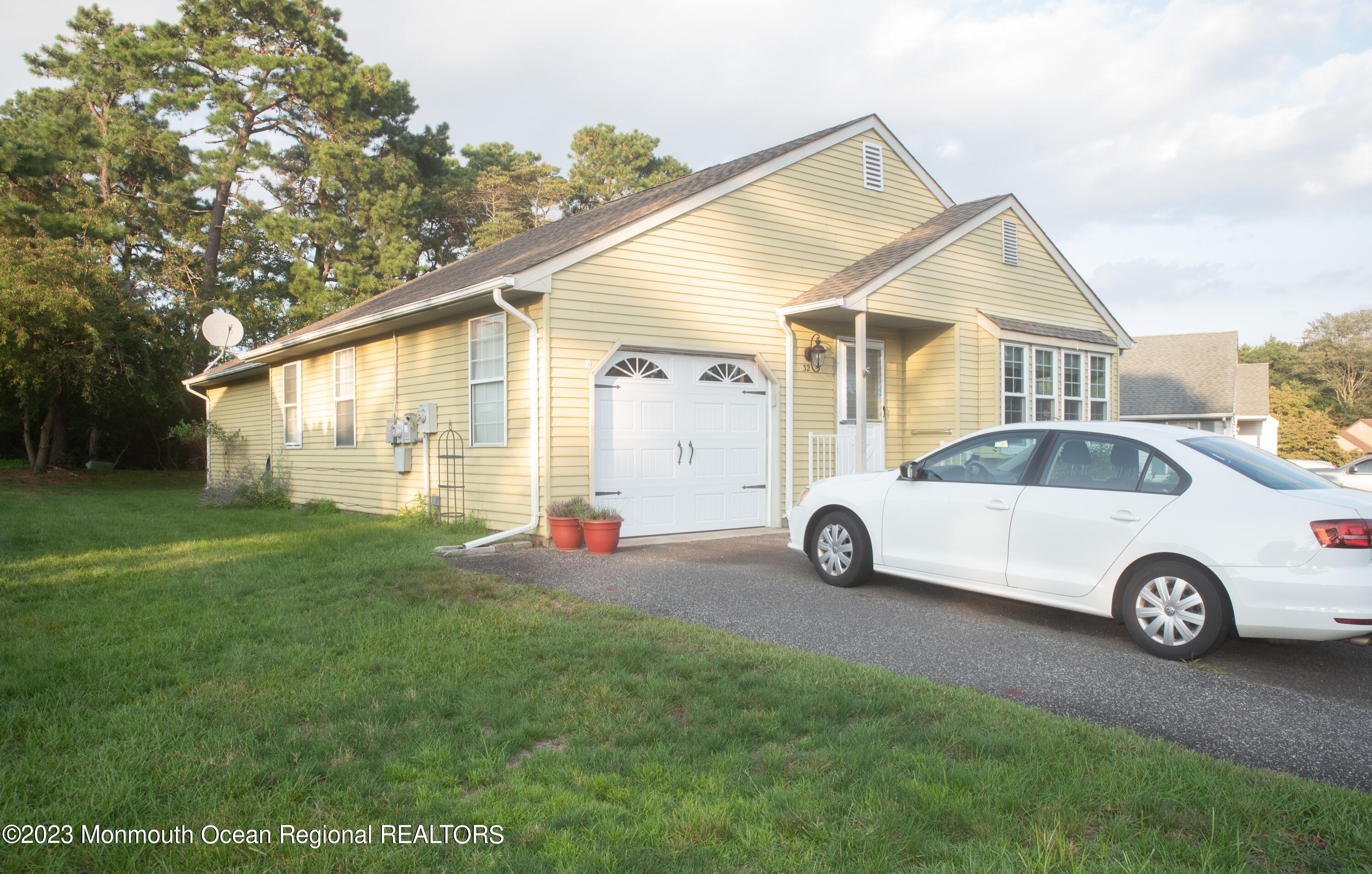 32 Ashley Road Whiting, NJ 08759 - Photo 1 of 23 a view of a house with a yard and parking space
