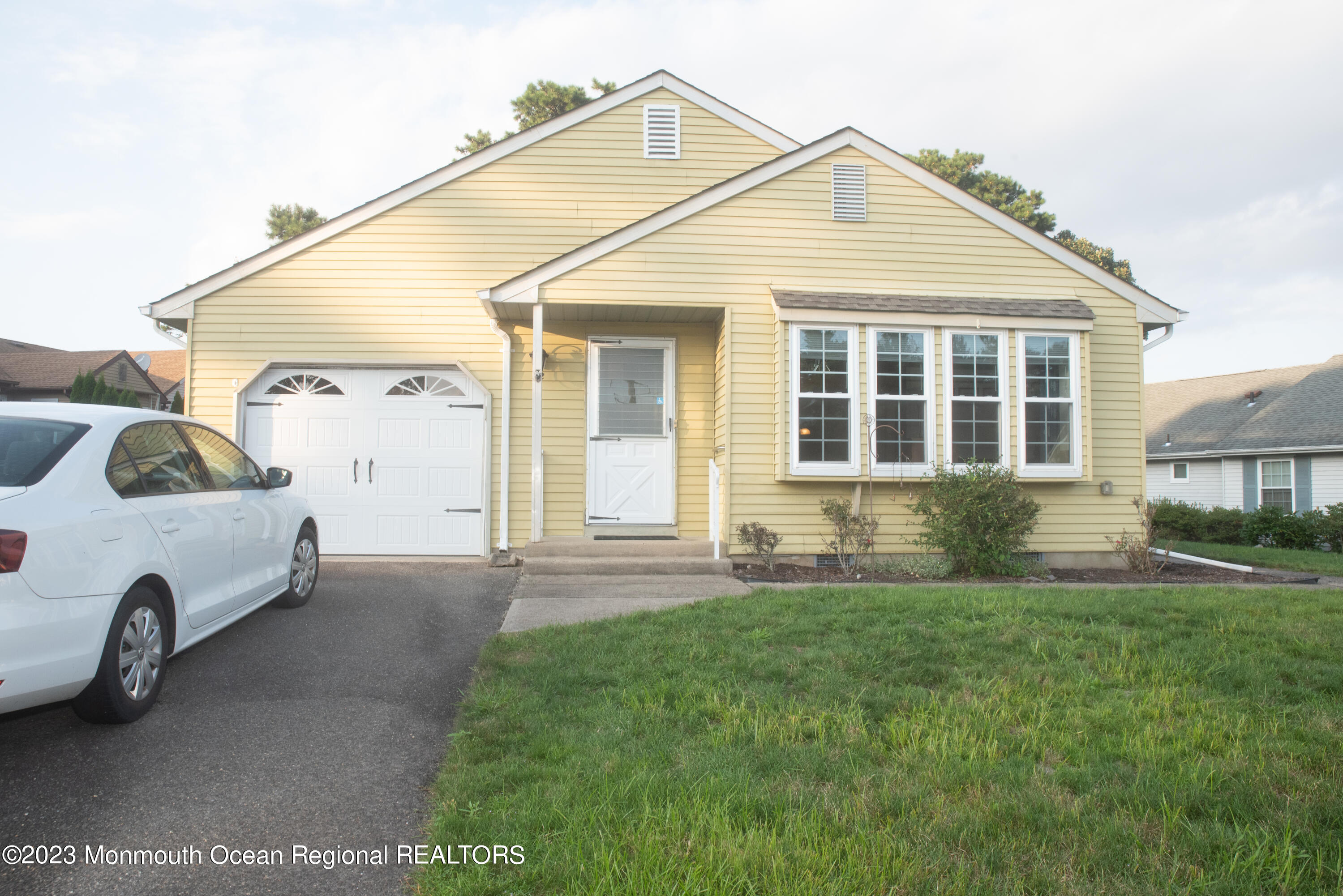 32 Ashley Road Whiting, NJ 08759 - Photo 2 of 23 a view of a white house next to a yard and palm trees