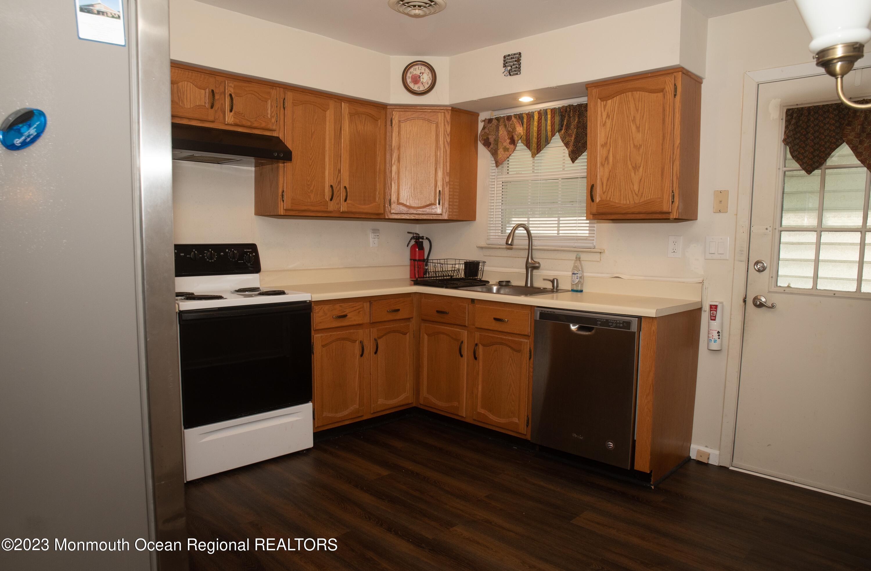 32 Ashley Road Whiting, NJ 08759 - Photo 22 of 23 a kitchen with a sink a stove and cabinets