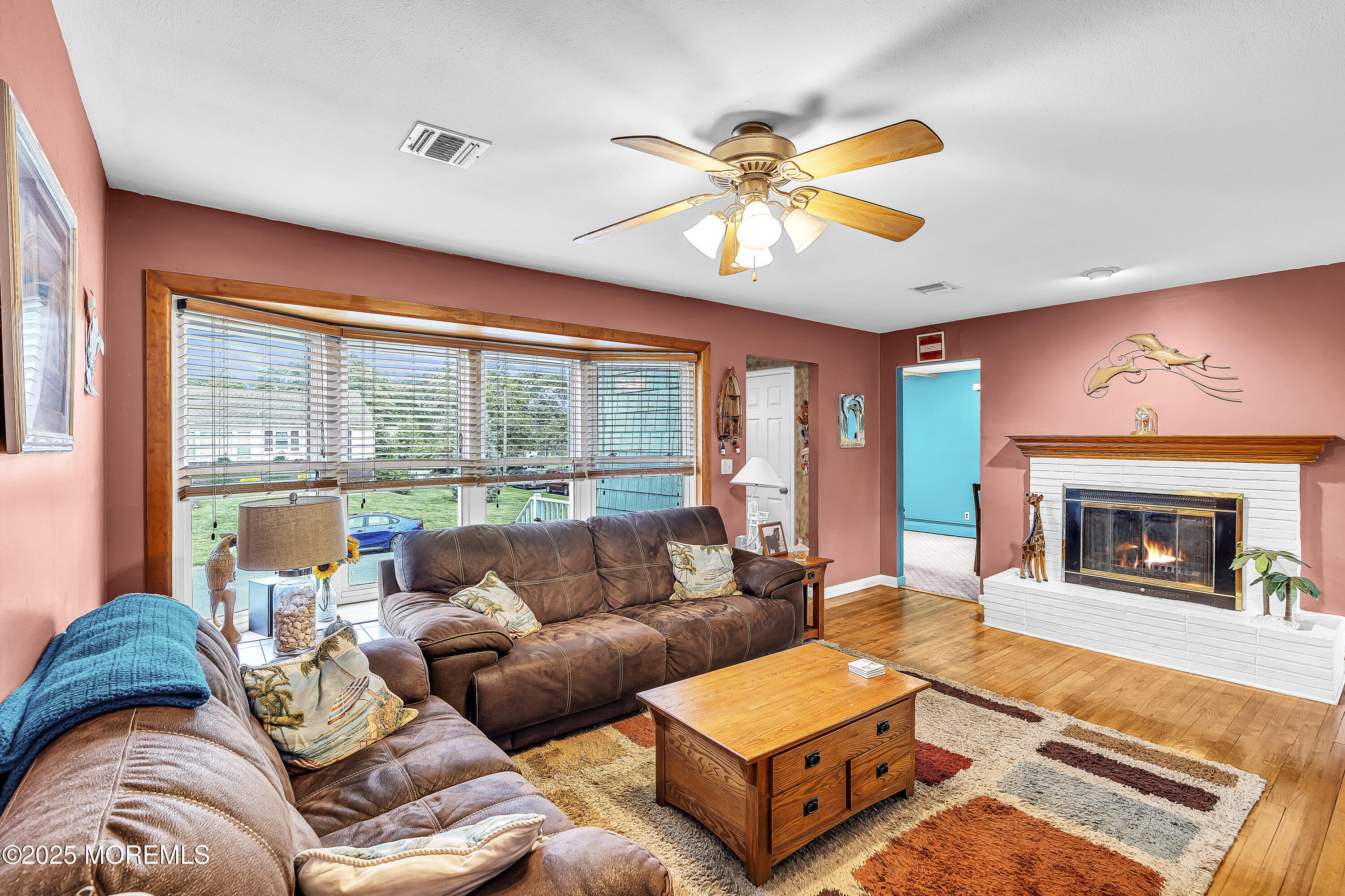 1400 Treeneedle Road Point Pleasant, NJ 08742 - Photo 11 of 45 a living room with furniture a fireplace and a large window