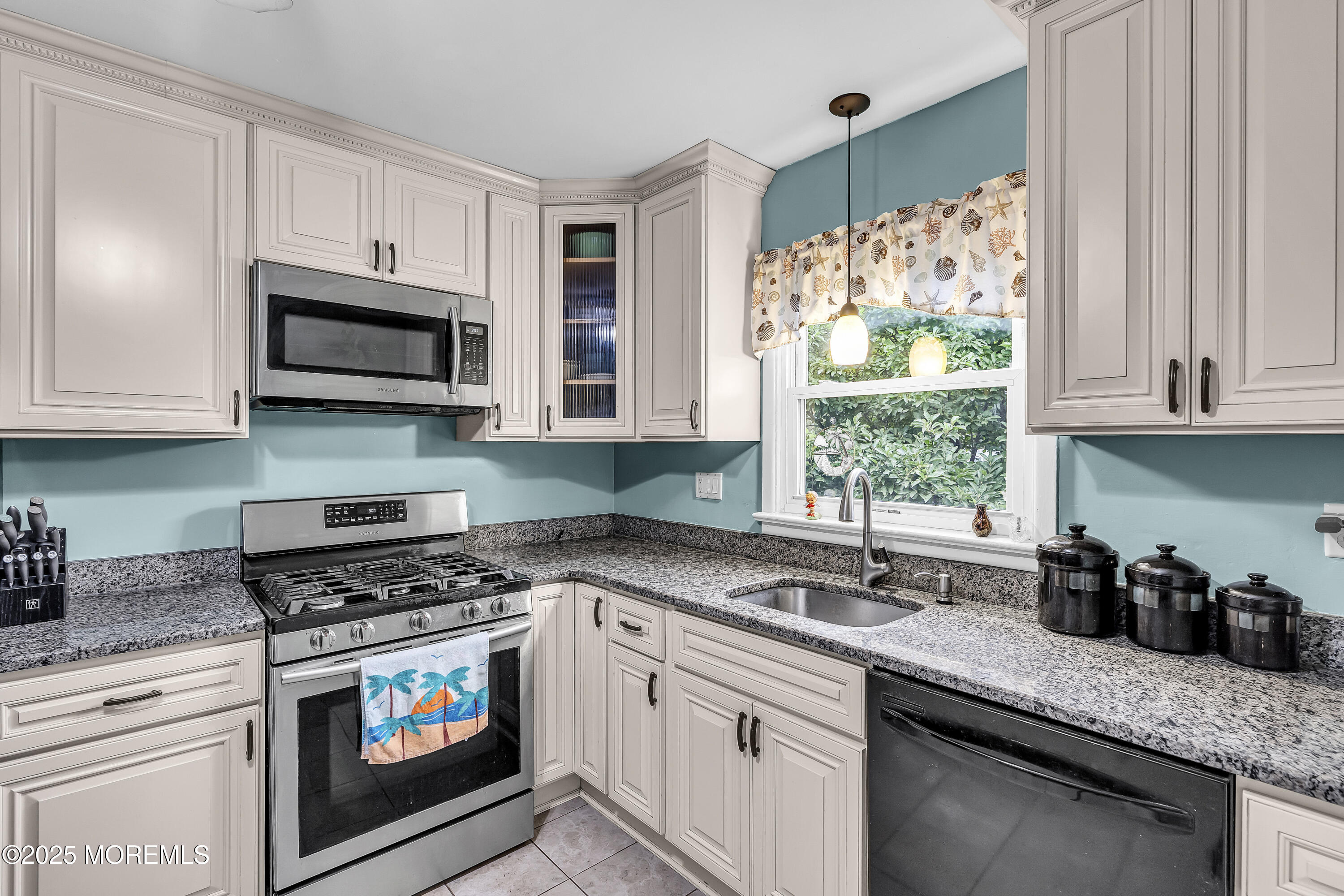 1400 Treeneedle Road Point Pleasant, NJ 08742 - Photo 16 of 45 a kitchen with granite countertop a sink a microwave a stove and cabinets