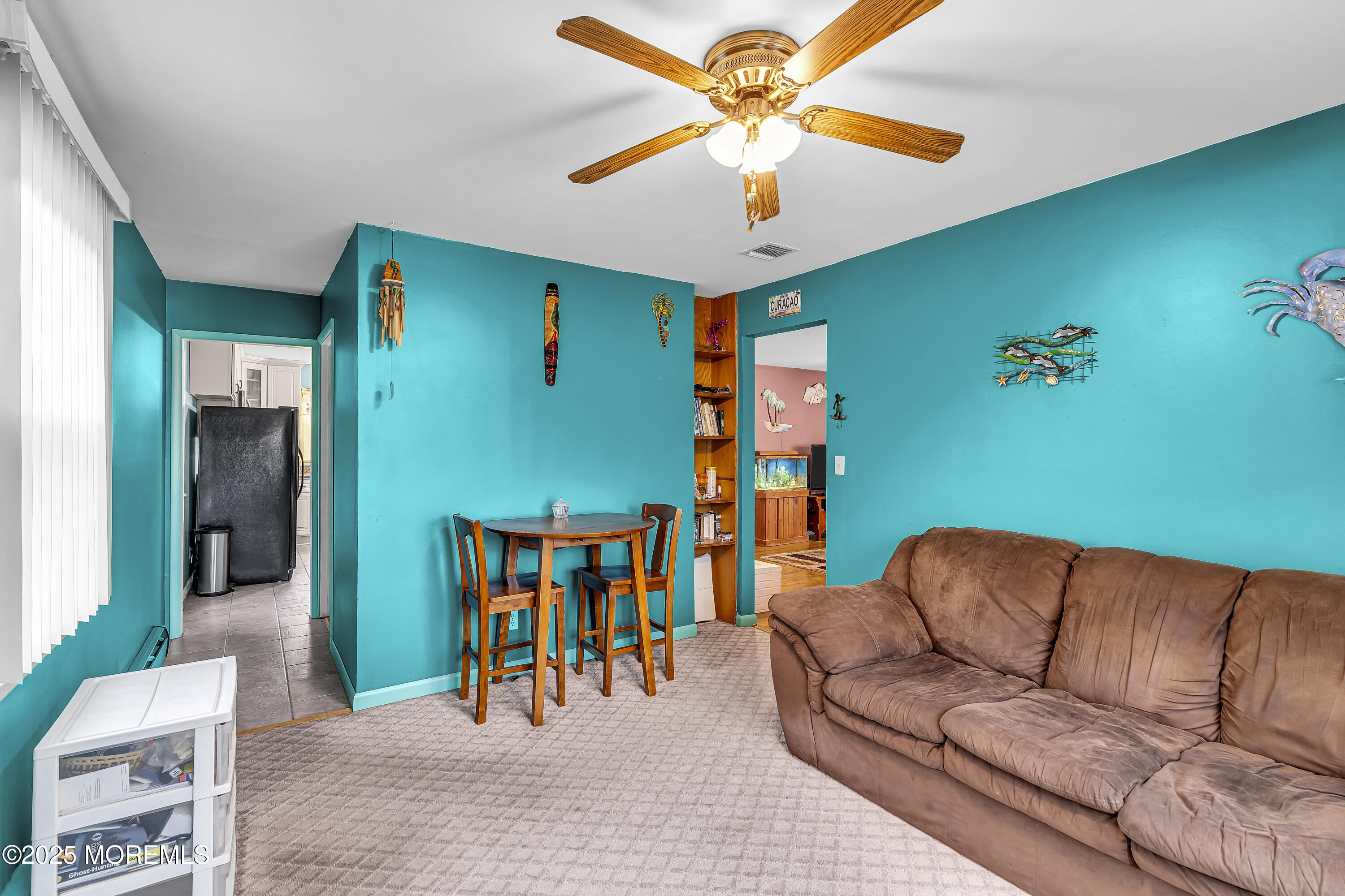 1400 Treeneedle Road Point Pleasant, NJ 08742 - Photo 22 of 45 a living room with furniture ceiling fan and a rug