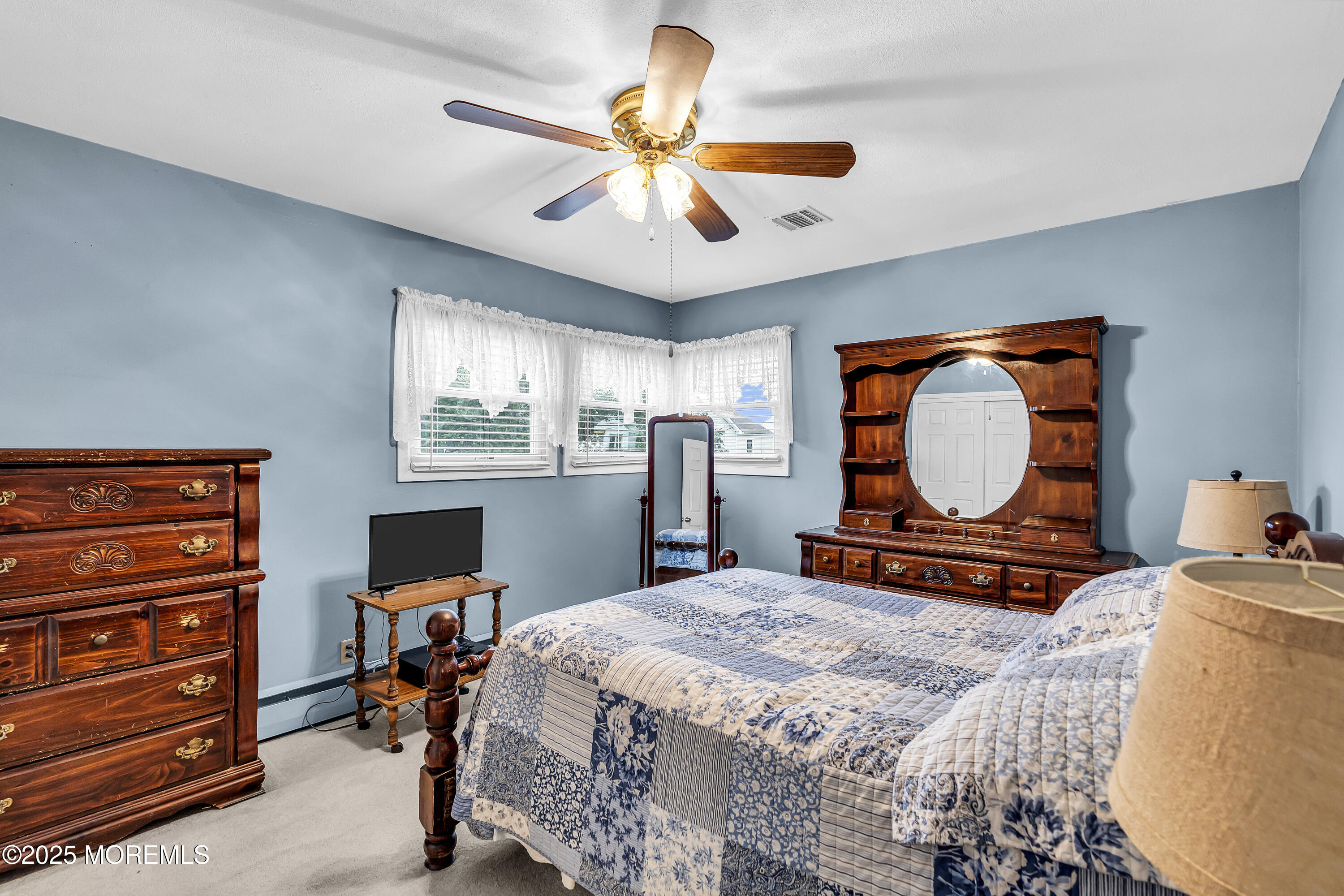 1400 Treeneedle Road Point Pleasant, NJ 08742 - Photo 24 of 45 a bedroom with a bed and a chandelier