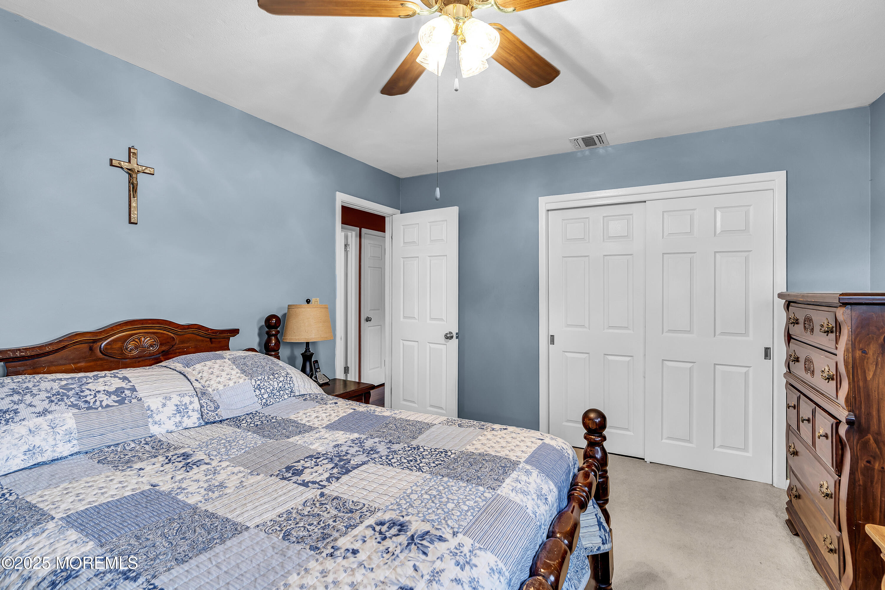 1400 Treeneedle Road Point Pleasant, NJ 08742 - Photo 25 of 45 a bedroom with a bed and a chandelier