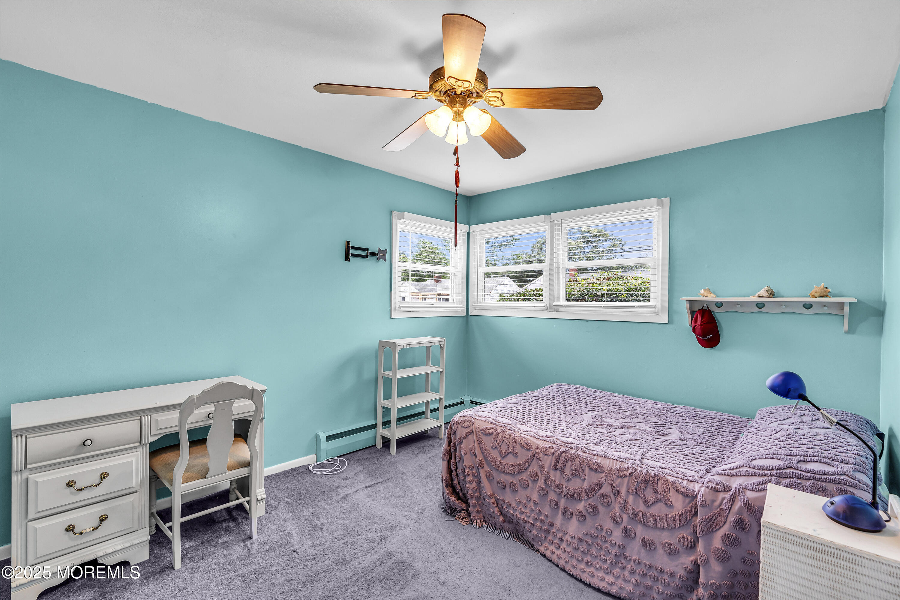 1400 Treeneedle Road Point Pleasant, NJ 08742 - Photo 27 of 45 a bedroom with a bed and a chandelier