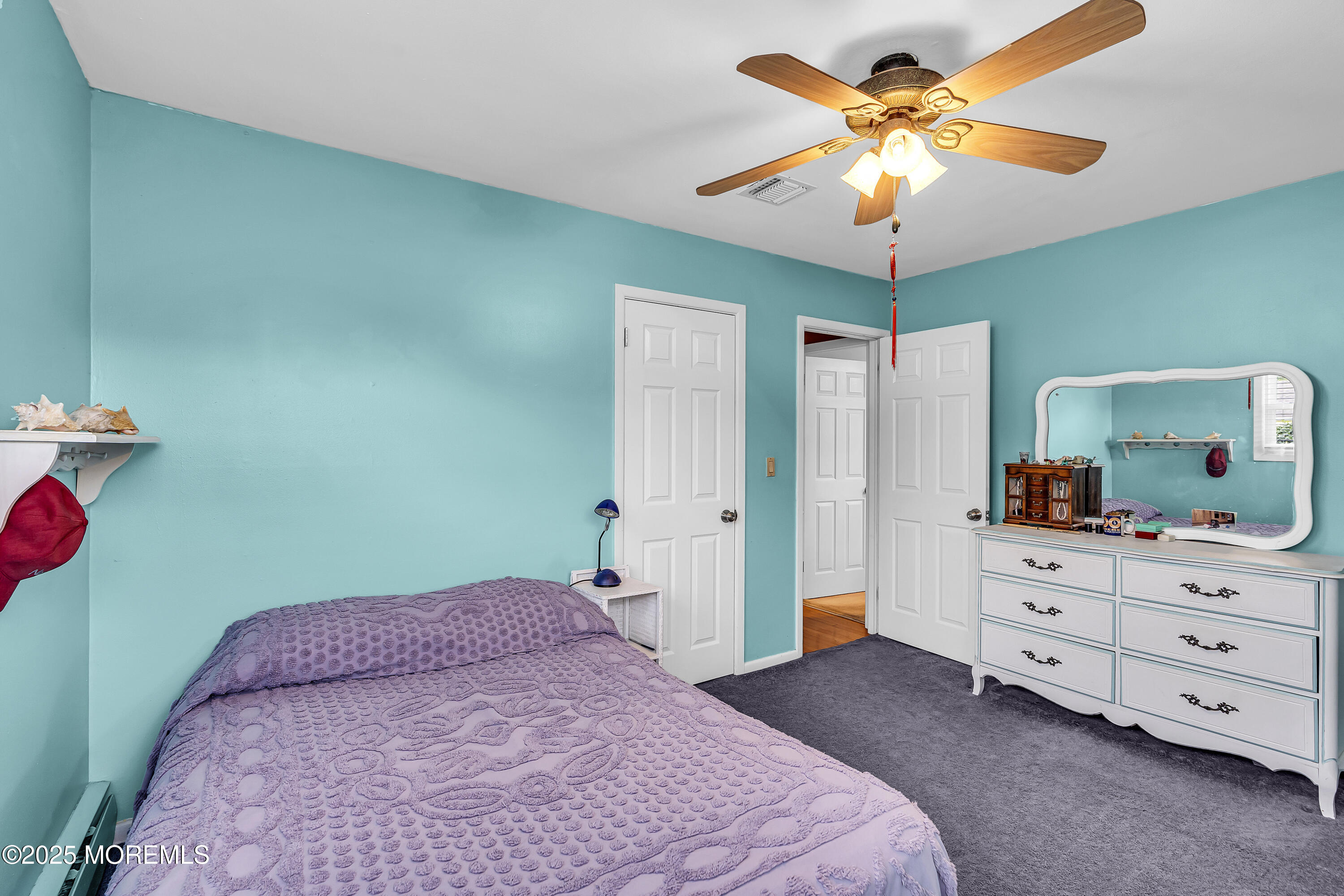 1400 Treeneedle Road Point Pleasant, NJ 08742 - Photo 28 of 45 a bedroom with a bed and a chandelier